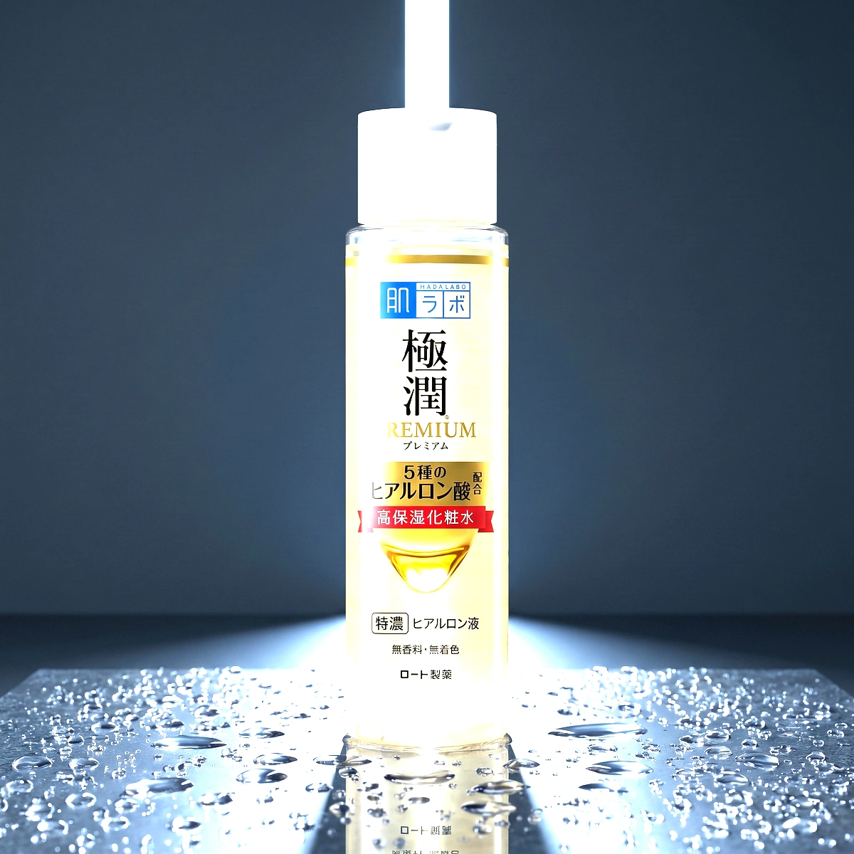 Hada Labo Gokujyun Premium Lotion pump on dark stone, with a frosted bottle and a blue band