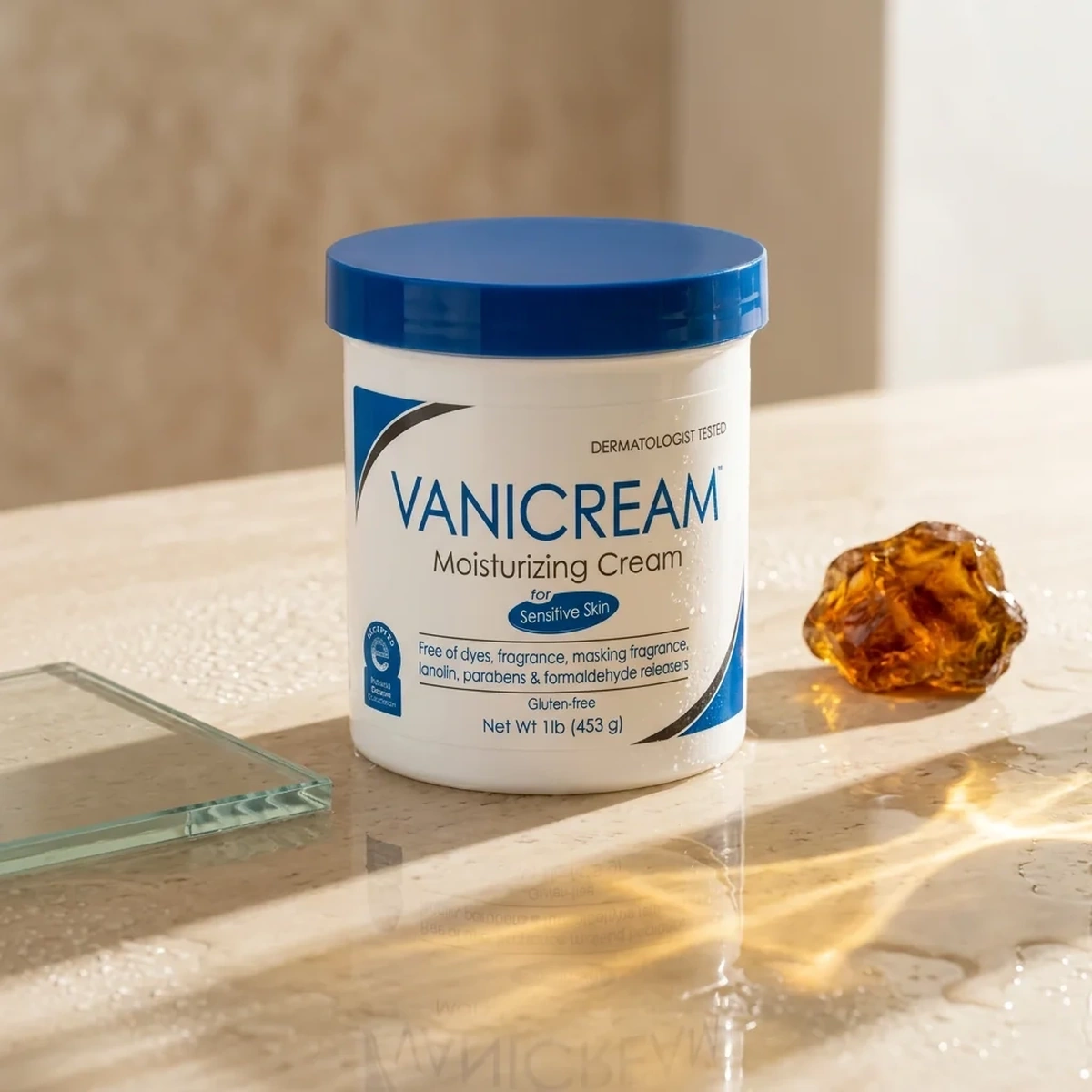 Vanicream Moisturizing Cream tub on a dewy sunlit mineral vanity with amber and clear glass
